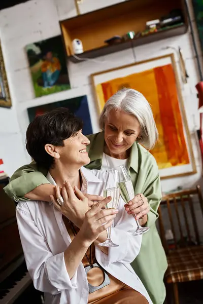 Two woman holding a glass of wine. — Stock Photo