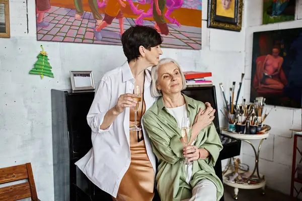 Two woman sitting together in an art studio, deep in discussion. — Stock Photo