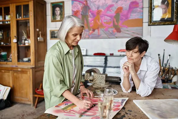 Two women happily painting together in a cozy studio. — Stock Photo