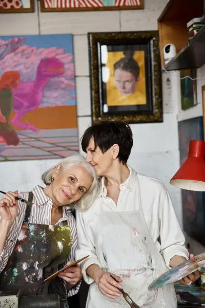 Mature lesbian couple creating art in a studio. — Stock Photo