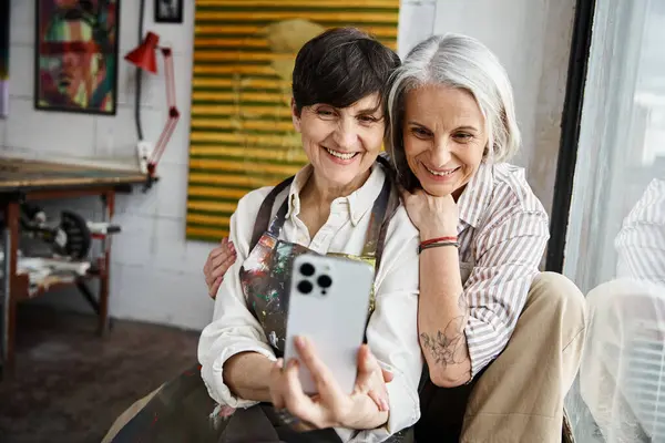 Two women joyfully taking a selfie with phone. — Stock Photo