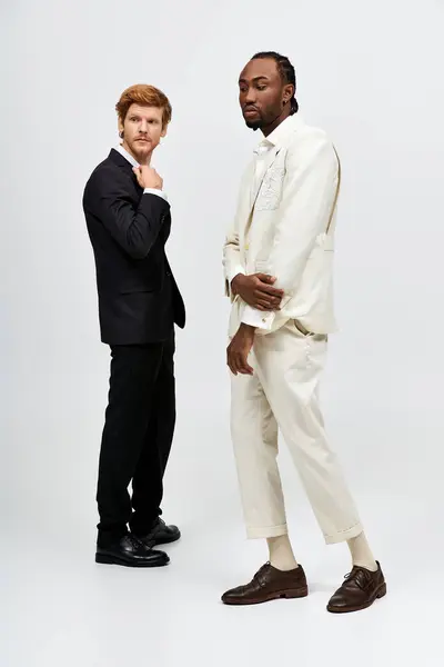 Two handsome multicultural men in elegant suits standing side by side. — Stock Photo
