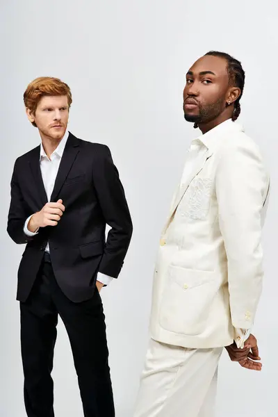 Two handsome men in dapper suits stand side by side. — Stock Photo
