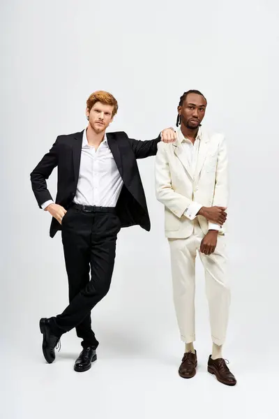 Two multicultural men in elegant suits standing together. — Stock Photo