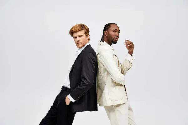 Two multicultural men in elegant suits stand side by side. — Stock Photo