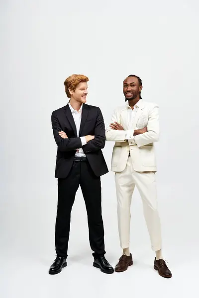 Two handsome multicultural men in elegant suits pose together. — Stock Photo