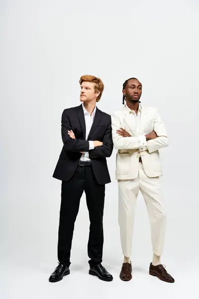 Two handsome multicultural men in elegant suits standing together. — Stock Photo