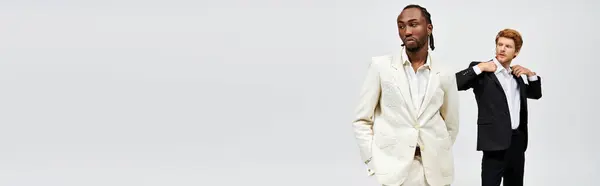 Two elegant men in stylish suits posing together. — Stock Photo