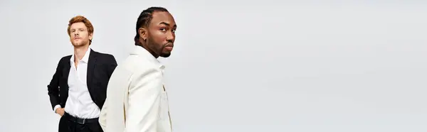 Two elegant multicultural men stand side by side against a white backdrop. — Stock Photo