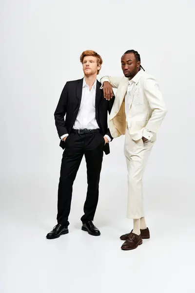 Two handsome multicultural men in elegant suits standing together. — Stock Photo