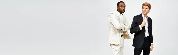 Two multicultural men in elegant attire stand together. — Stock Photo