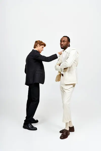 A multicultural men looking sharp in stylish suits. — Stock Photo