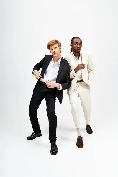 Two multicultural men in stylish suits posing confidently for the camera. — Stock Photo