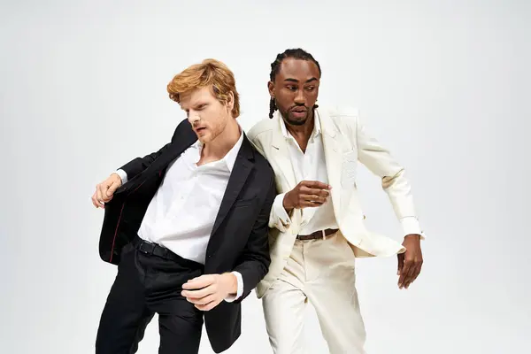 Two multicultural men in stylish suits posing elegantly for a portrait. — Stock Photo
