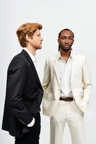 Two handsome multicultural men in elegant suits pose together. — Stock Photo