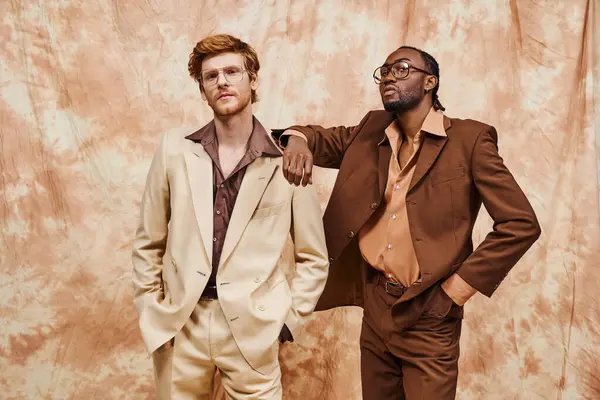 Two elegant multicultural men in stylish suits standing side by side. — Stock Photo