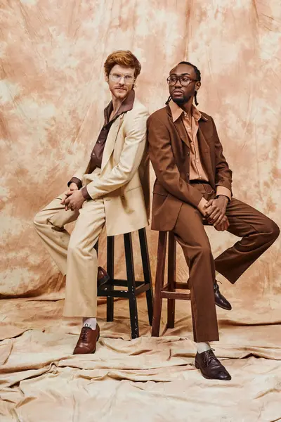 Homens multiculturais em traje elegante sentado em banquinho de madeira. — Fotografia de Stock