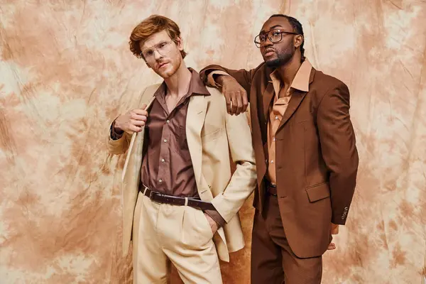 Two dapper men stand side by side in stylish suits. — Stock Photo