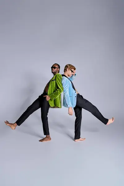 Two multicultural men in elegant attire standing together in the center. — Stock Photo