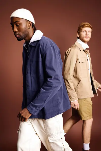 Two stylish men in jackets and shorts leisurely walking together. — Stock Photo