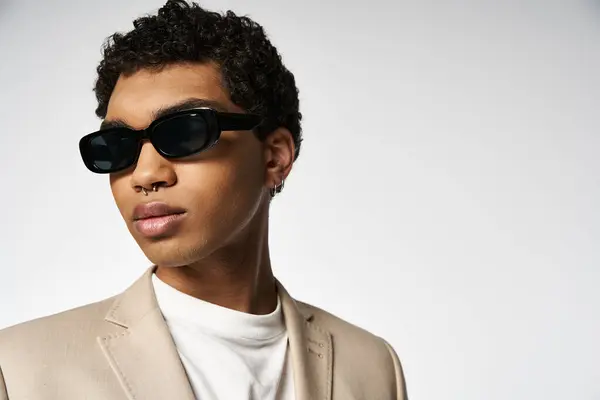 Stylish young man in tan suit and sunglasses. — Stock Photo