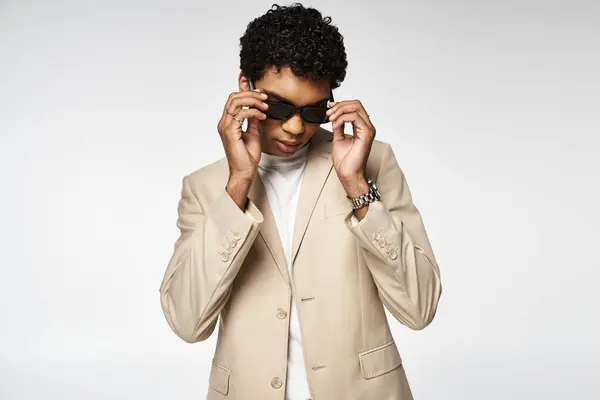 Stylish young man in tan suit and sunglasses. — Stock Photo