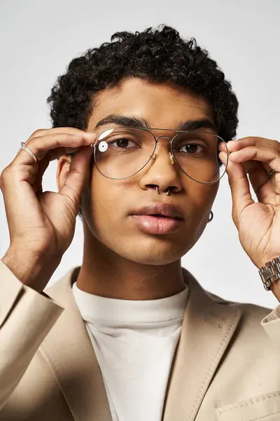 Handsome young man in glasses and tan suit. — Stock Photo