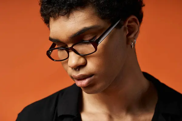 African American man wearing glasses on vivid orange background. — Stock Photo