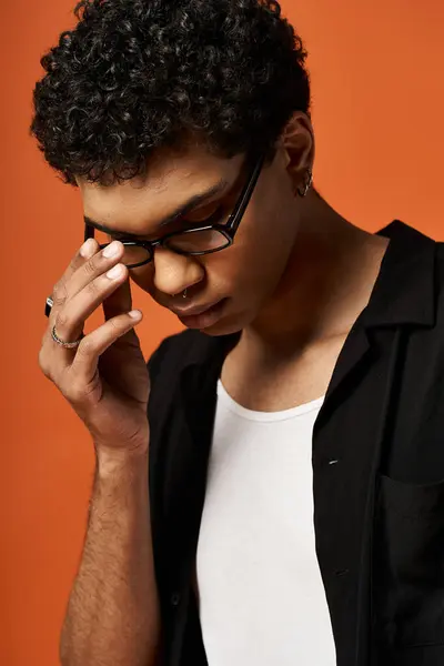 Handsome young African American man in black shirt and stylish glasses. — Stock Photo