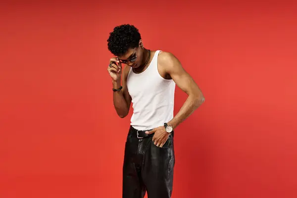 Handsome African American man in white tank top and leather pants with stylish sunglasses. — Stock Photo