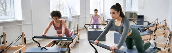 A diverse group of women engaging in various exercises at the gym. — Stock Photo