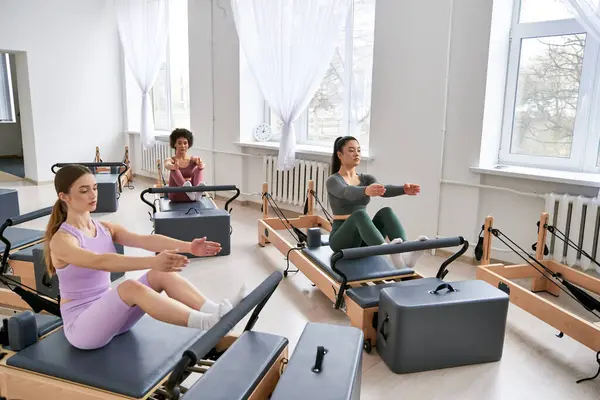 Group of people sitting on pilates in a room. — Stock Photo