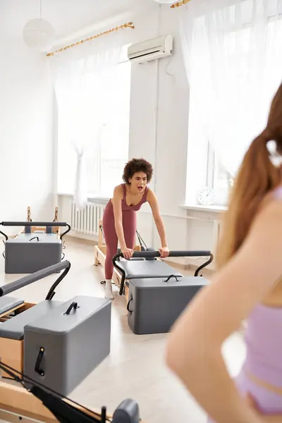 Two alluring women exercising actively, pilates. — Stock Photo