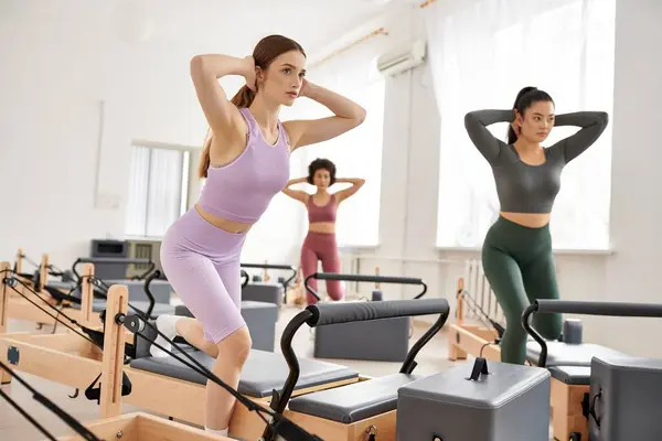 Group of women in a gym engaging in various exercises and activities. — Stock Photo