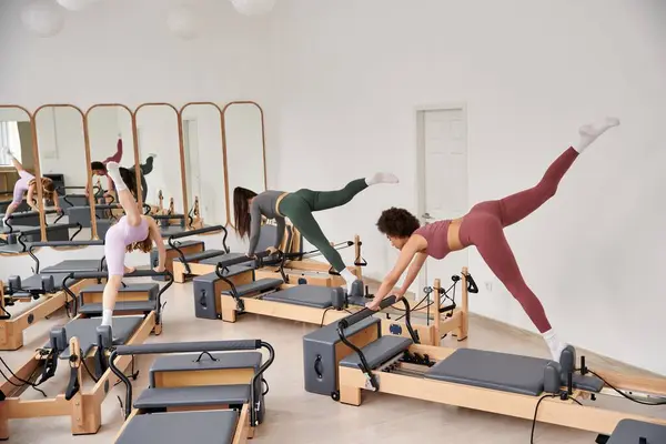 Un grupo de mujeres bastante deportivas haciendo ejercicios en un gimnasio. - foto de stock