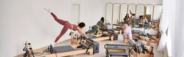 Les femmes séduisantes s'engagent dans une séance de Pilates dans une salle de gym. — Photo de stock