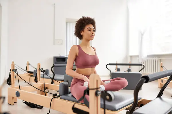 A sporty woman practices pilates in a stylish room. — Stock Photo