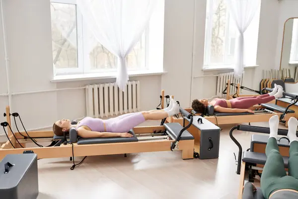 Two sporty women exercising in a serene room. — Stock Photo