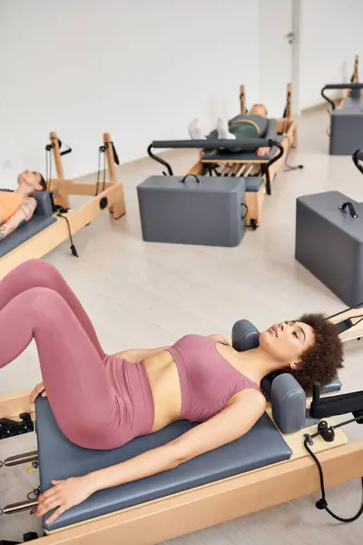 Beautiful women engaging in a pilates workout at the gym. — Stock Photo