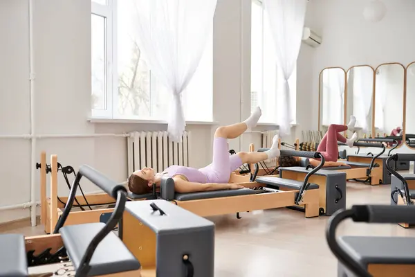Fit women engaging in a pilates workout at the gym. — Stock Photo