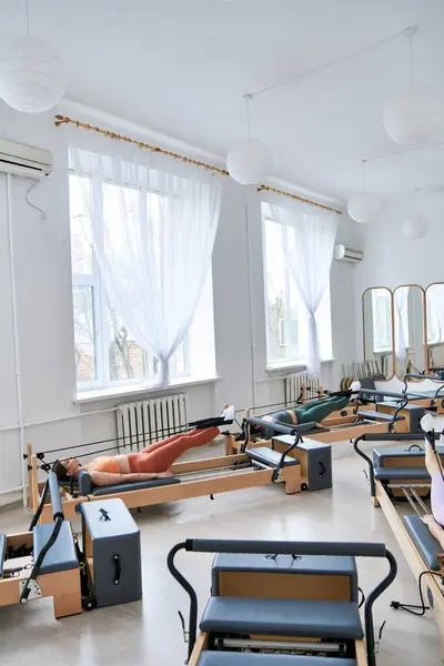 Vibrant women enjoying a pilates class. — Stock Photo