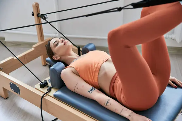 Fit woman on a pilates lesson. — Stock Photo