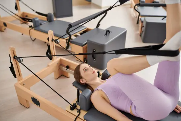 Sporty woman exercises in gym. — Stock Photo