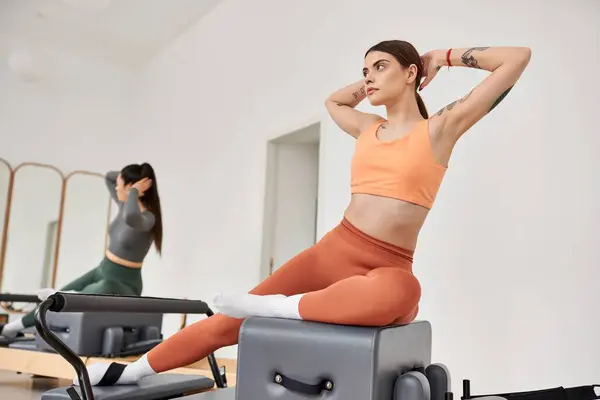 Belas mulheres esportivas se exercitando durante a aula de pilates. — Fotografia de Stock