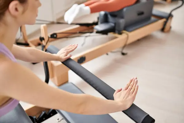 A sporty woman engages in a pilates lesson in the gym. — Stock Photo