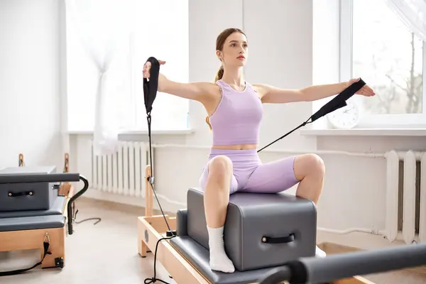Appealing woman in sportwear exercising on pilates lesson. — Stock Photo