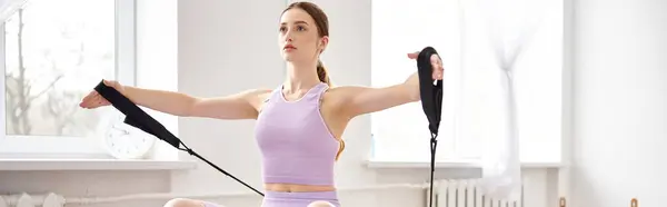 Attractive woman in sportwear exercising on pilates lesson. — Stock Photo