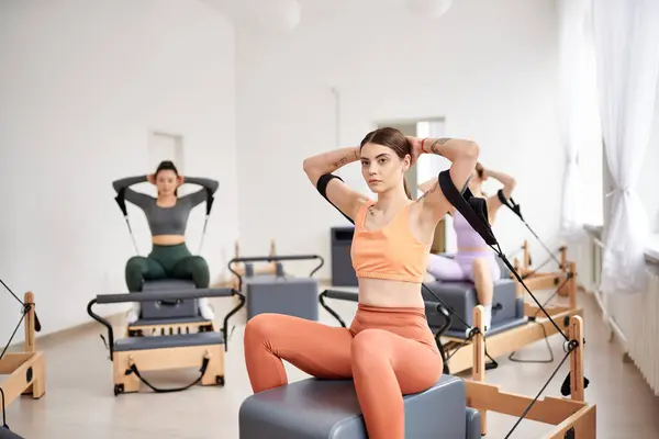 Fit women in sportswear during pilates in a gym together. — Stock Photo