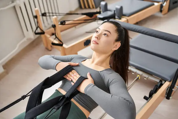 Alluring woman actively practising while on pilates lesson. — Stock Photo