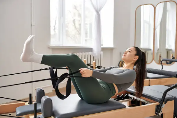 Sporty woman actively practising while on pilates lesson. — Stock Photo